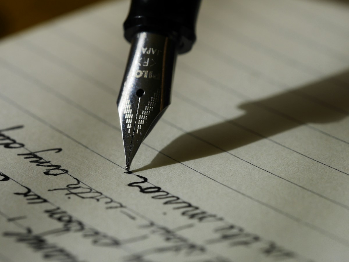 Notebook and writing tools representing text editing and capitalization formatting