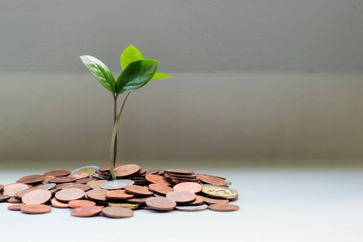 Savings jar and coins representing compound interest and long-term savings growth