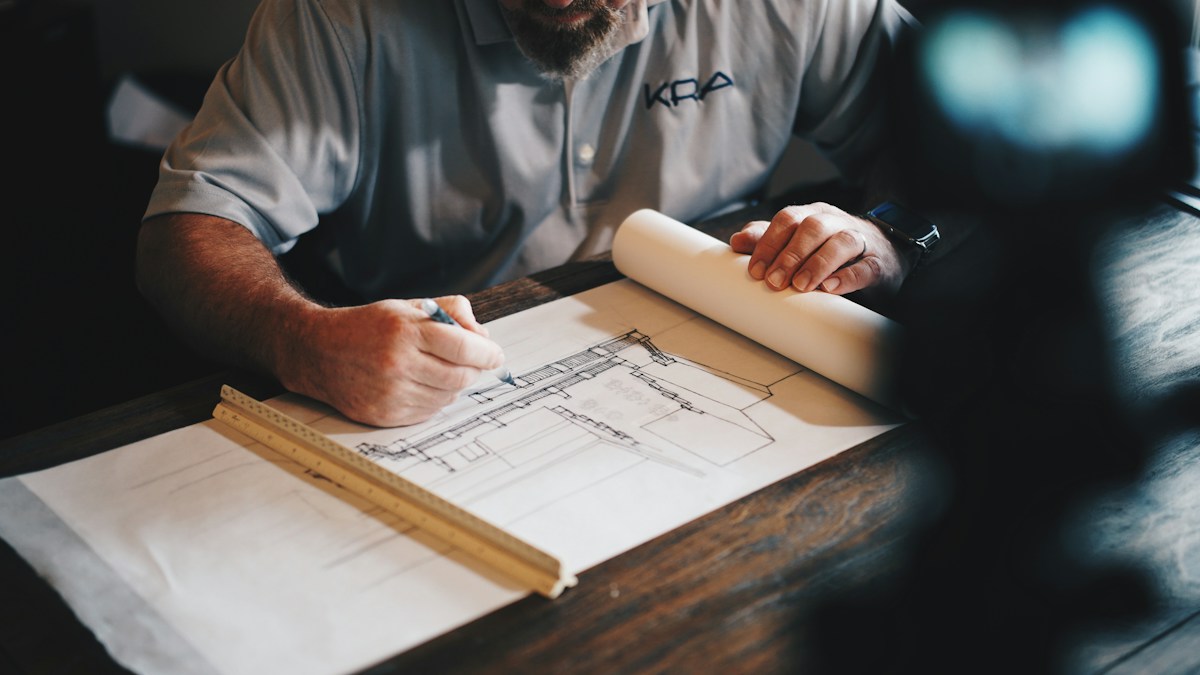 Architectural plan and measuring tools used to measure boundaries